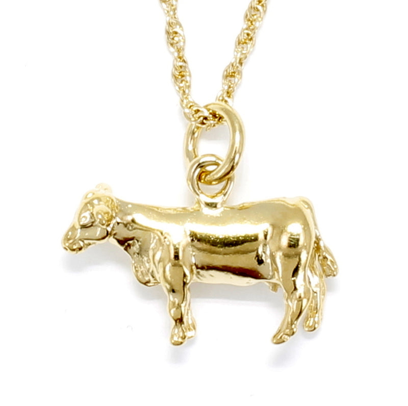 A gold cow necklace and pendant.