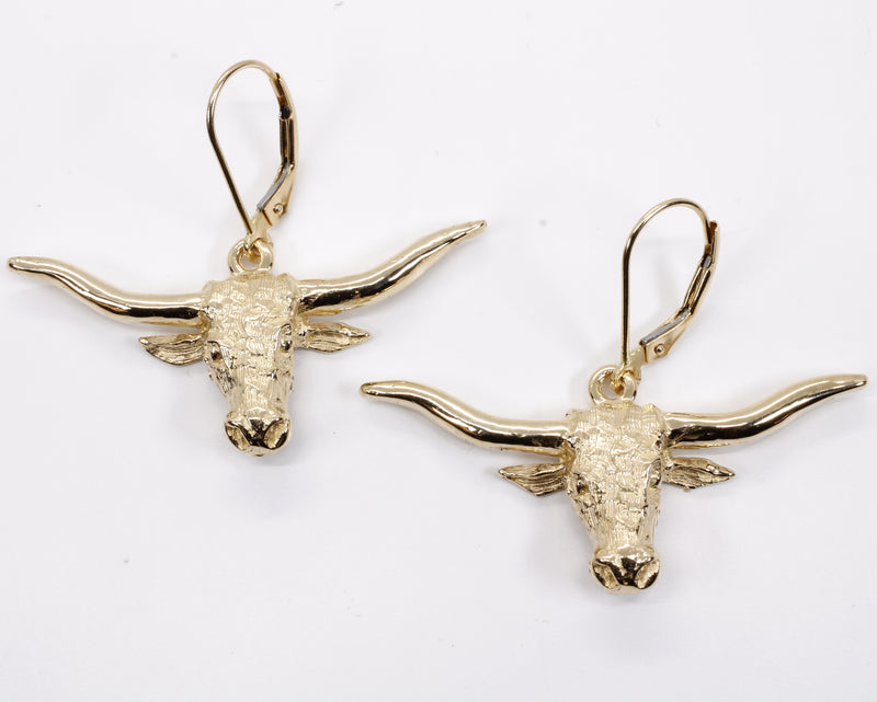 A pair of gold Texas longhorn earrings.