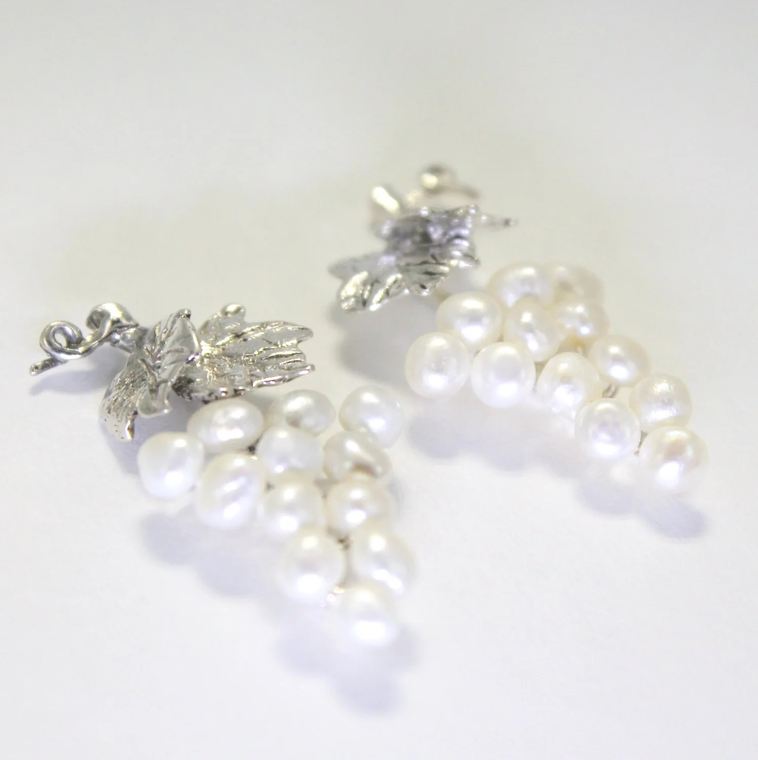 What is the color of the pearls in the earrings?