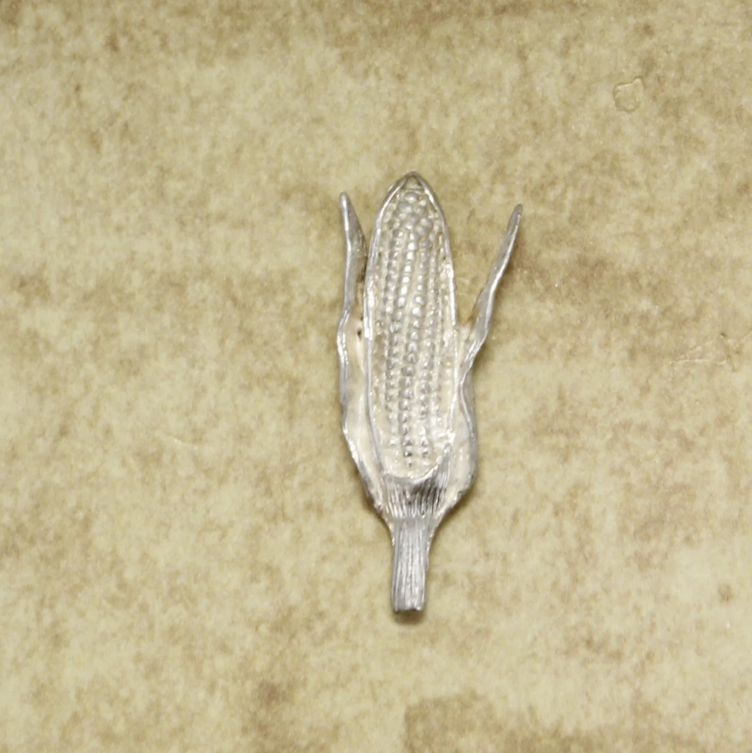 What is the finish like on the corn lapel pin or tie tack?