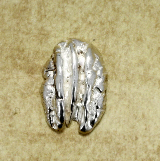 What material is the tie tack or lapel pin made from?