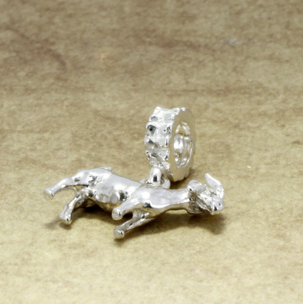 What material is the goat charm made from?