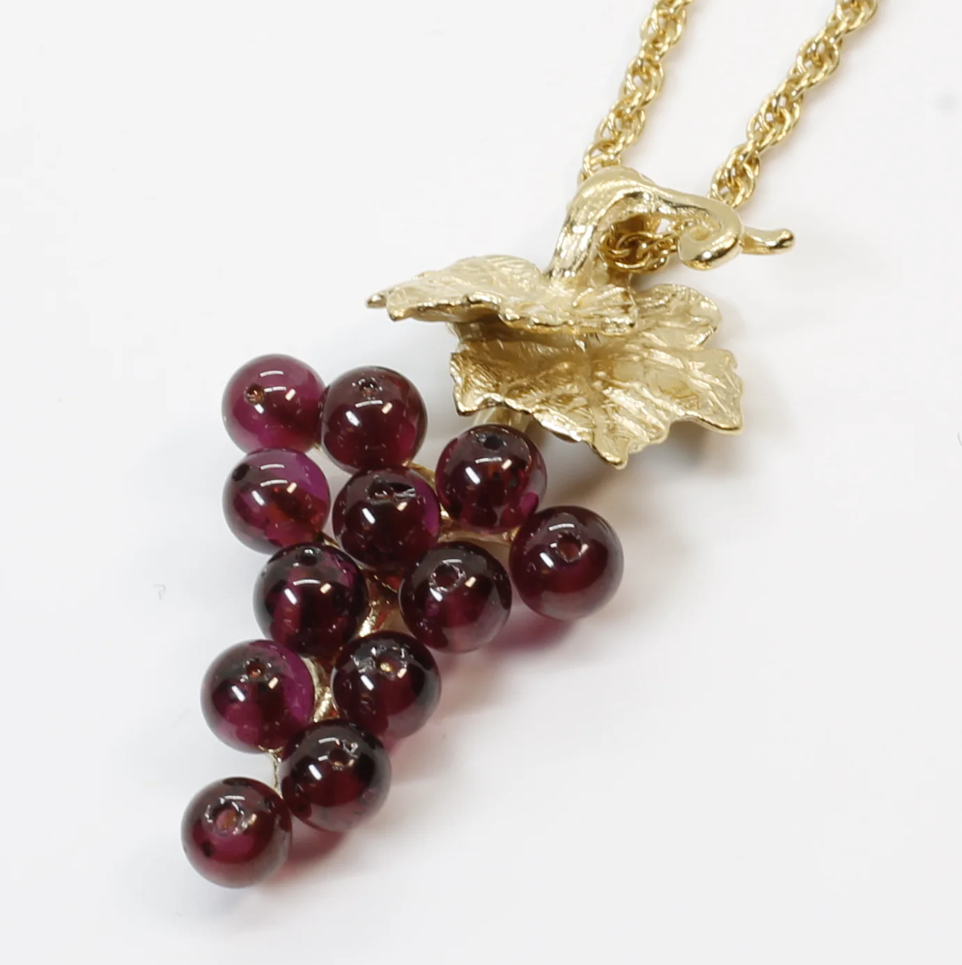 Garnet Grape Cluster Necklace with Two Small Grape Leaves in 14kt. Gold Vermeil Questions & Answers