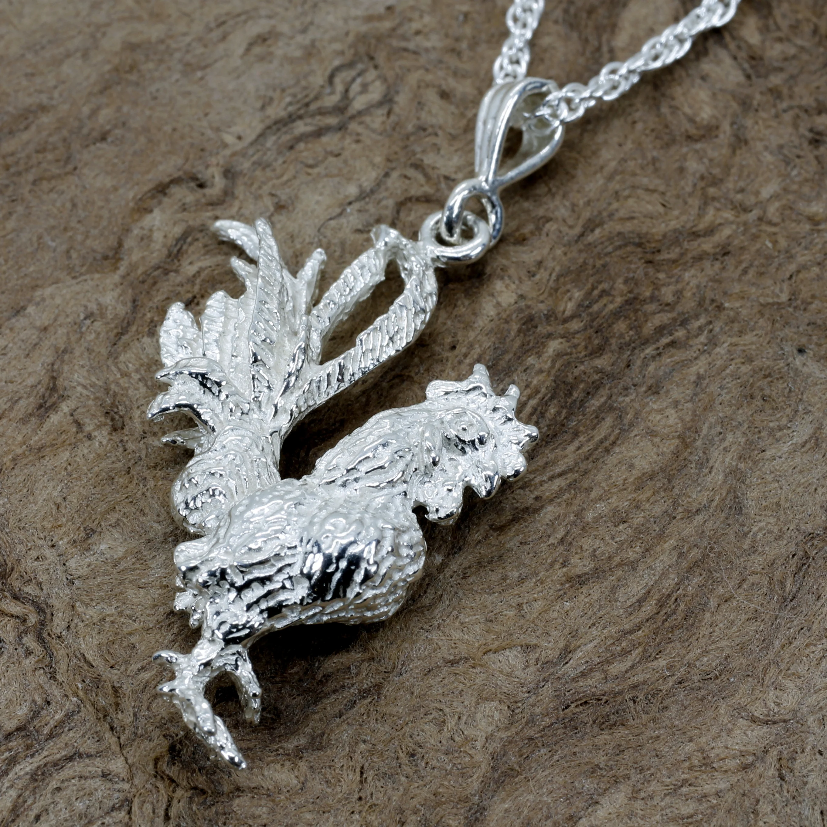 What is the material of the rooster necklace?