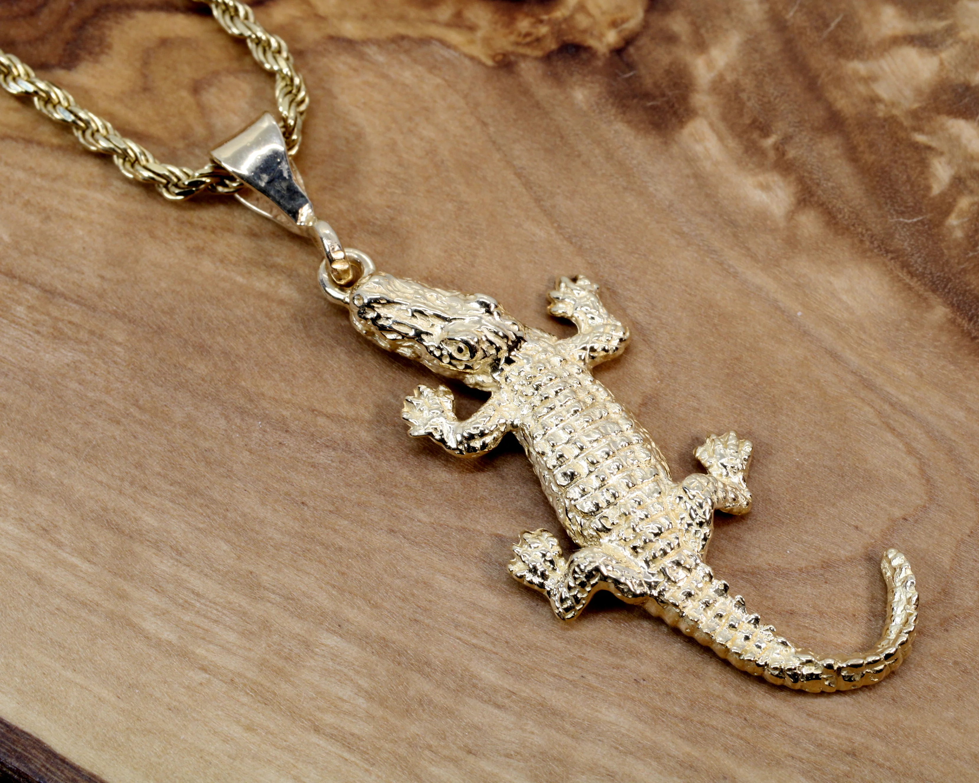 What is the material of the alligator necklace?