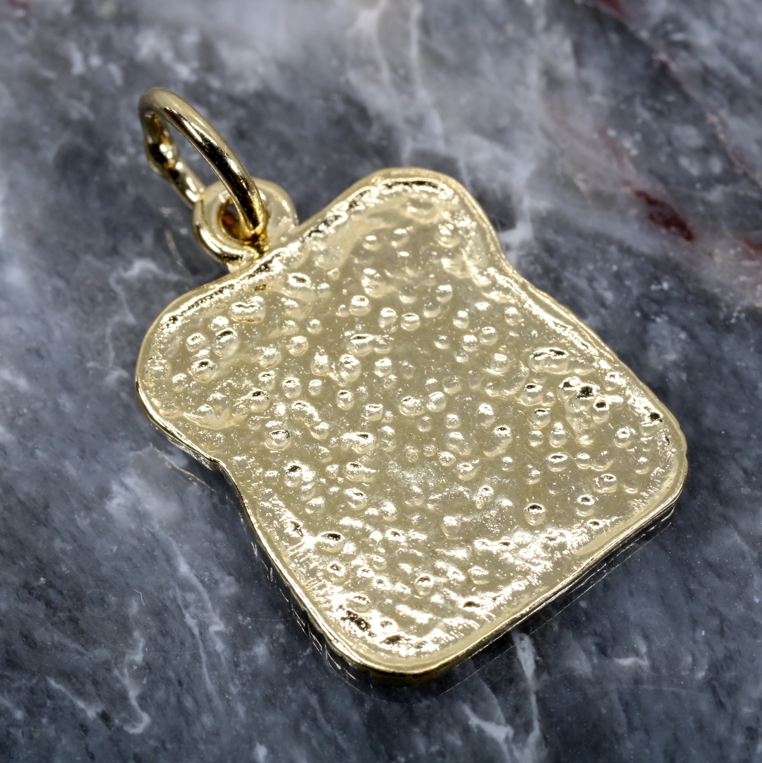 What materials is the necklace or charm made from?