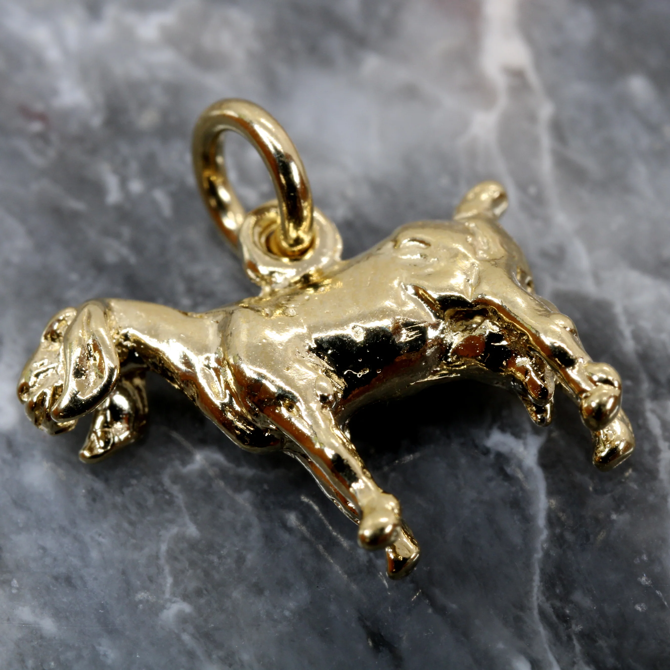 What material is the goat charm made of?